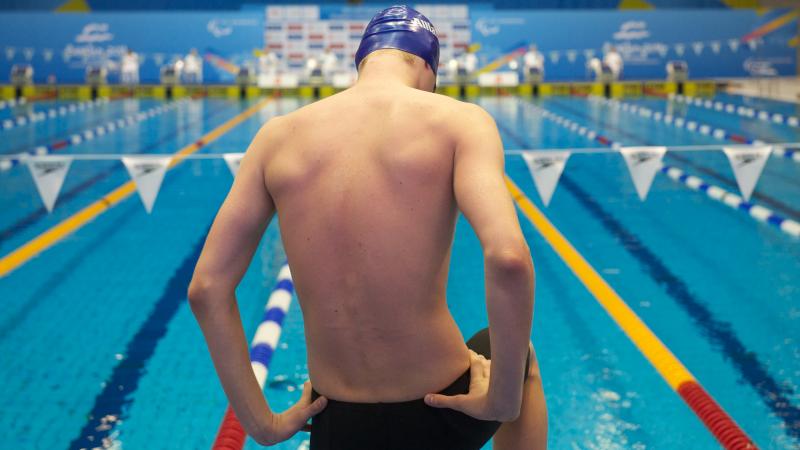 Ihar Boki, from Belarus, is preparing his 400m Freestyle S13 race A picture of a man standing in front of a pool