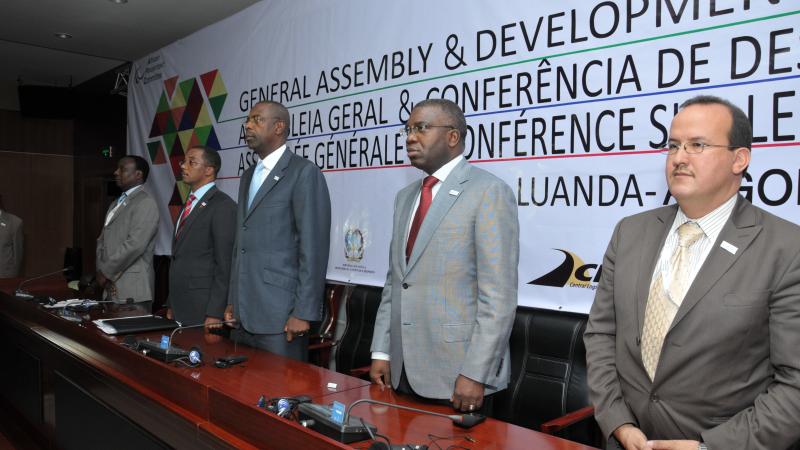 The African Development Conference A picture of 5 men standing behind a desk