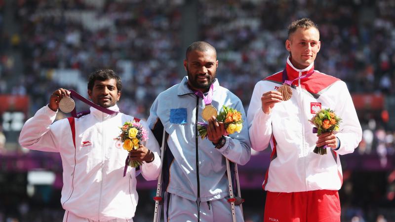 Iliesa Delana A picture of men on a podium with medals around their neck