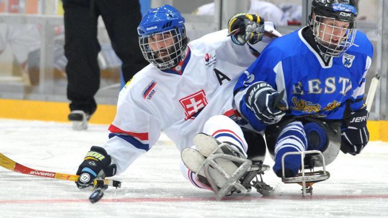 Estonia ice sledge hockey A picture of 2 men in sledge fighting the puck during a ice hockey match