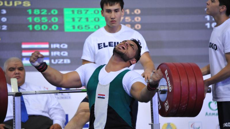 Rasool Mohsin at 2015 IPC Powerlifting Asian Open Championships in Almaty, Kazakhstan Man sitting on bench, celebrating