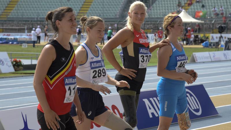 Women's long jump T42-44 - Grosseto 2016 Group of women with leg prosthetics standing in a stadium, one is looking into the camera