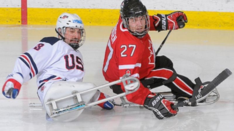 Brad Bowden A picture of two men in sledges playing ice hockey