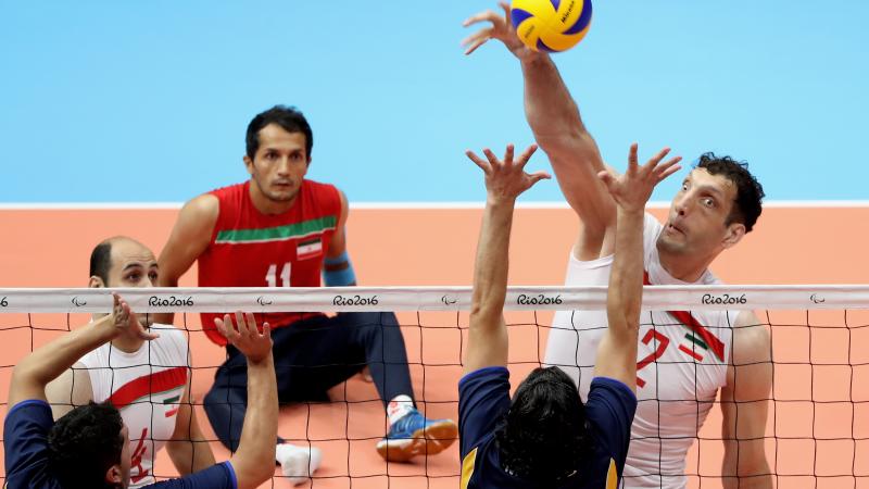Morteza Mehrzadselakjani - Iran a male sitting volleyball player attempts a block
