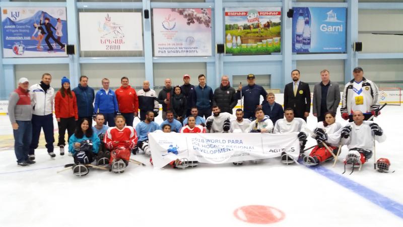 Para Ice Hockey Development Camp Armenia A group of people on sledges on an ice hockey rink
