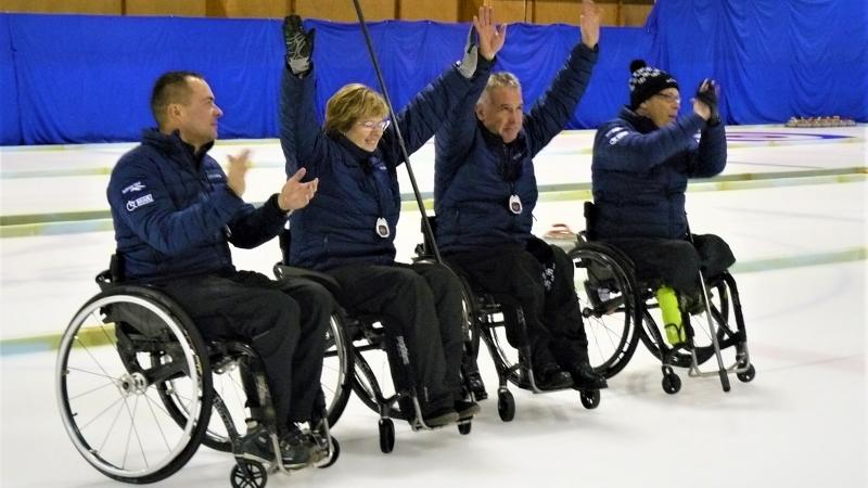 Viljar Villiste, Andrei Koitmae, Ain Villau and Signe Falkenberg - Estonia - Wheelchair curling Four Estonian wheelchair curling athletes celebrate a shot on the ice sheet