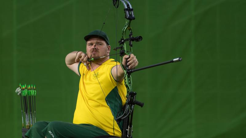 Jonathon Milne - Australia - archery Australian male archer in wheelchair pulls back on his bow