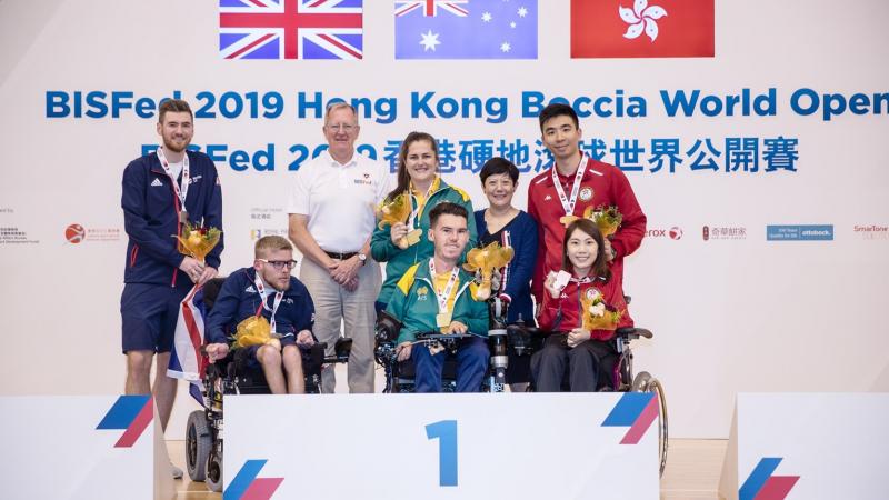 Daniel Michel - Australia - boccia Podium photo with three boccia players and their assistants posing for a photo