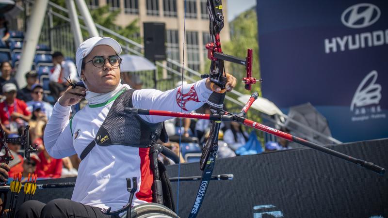Zahra Nemati - archery - Iran Female Iranian archer in a wheelchair looks on as she releases her arrow