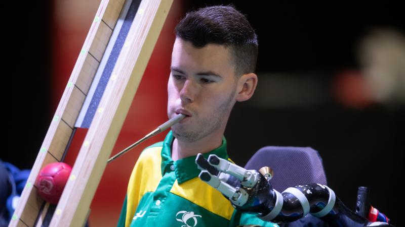 Daniel Michel - boccia - Australia Australian male boccia player holds device in mouth to push ball down ramp